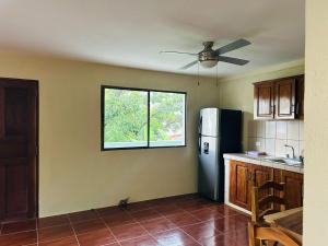 a kitchen with a black refrigerator and a window at Apartamentos Isabela in Casares