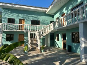 a blue house with stairs and a balcony at Apartamentos Isabela in Casares