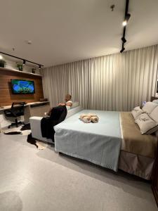 a person sitting in a room with two beds at 710 A Hotel Home Jade in Brasília
