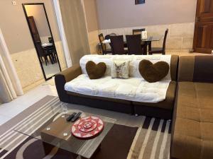 a living room with a couch and a table at Chez saly in Saint-Louis