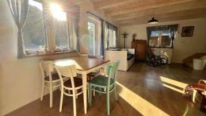 a kitchen and dining room with a table and chairs at Chata u Studnaře in Křivoklát