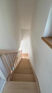 a staircase in a room with white walls and wooden floors at Chata u Studnaře in Křivoklát