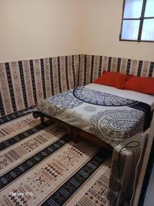 a bed in a room with mats on the floor at Maison authentique in Bou Noura