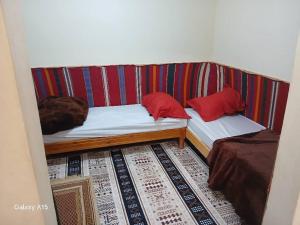 a couch with two pillows on it in a room at Maison authentique in Bou Noura