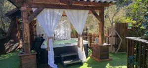 a gazebo with a tub in a yard at GITES O FIL DE L'EAU piscine spa accès rivière in Omessa