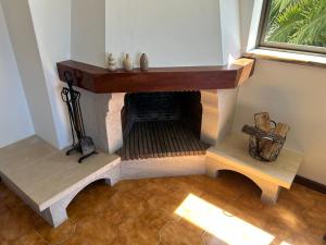 a living room with a fireplace and a wooden table at The Urban Terrace in Figueira da Foz