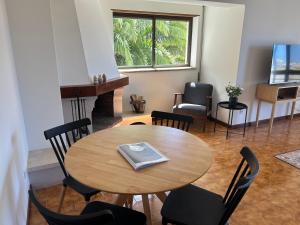 a room with a table and chairs and a fireplace at The Urban Terrace in Figueira da Foz