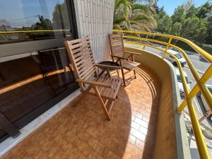 two chairs sitting on top of a balcony at The Urban Terrace in Figueira da Foz +15 photos