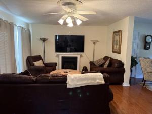a living room with two couches and a ceiling fan at Three Springs Plus in Lovingston