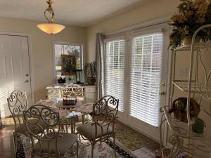 a dining room with a table and chairs and windows at Three Springs Plus in Lovingston
