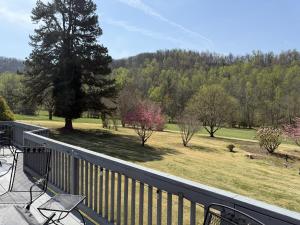 a balcony with a view of a field and trees at Three Springs Plus in Lovingston