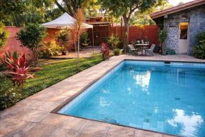 a swimming pool in the backyard of a house at Chill House Buzios in Búzios