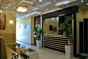 a lobby with potted plants and a reception desk at Shine residence in Budva