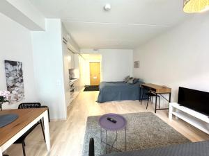 a bedroom with a bed and a table in a room at Easy Stay Rooms & Apartments near Airport in Vantaa