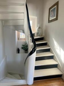 a spiral staircase in a home with a window at NAO Eifelhaus von 1875 mit Garten in Üxheim