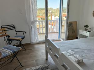 a bedroom with a bed and a view of a balcony at Ekati in Xylokastro