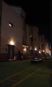 a group of buildings lit up at night at شاليهات بتلات الورد in Taif