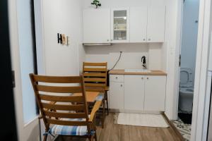 a kitchen with a table and chairs and a sink at Ekati in Xylokastro