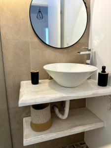 a bathroom with a white sink and a mirror at Ekati in Xylokastro