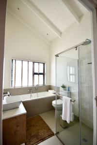 a bathroom with a tub and a toilet and a sink at Rustic Hills 39 in Swakopmund +6 photos