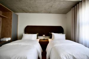two beds sitting next to each other in a bedroom at Rustic Hills 39 in Swakopmund