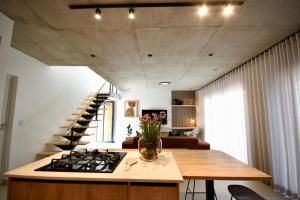 a kitchen with a stove and a table and a staircase at Rustic Hills 39 in Swakopmund