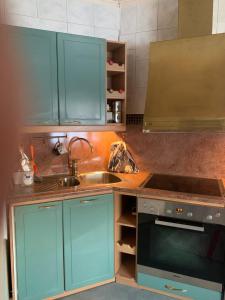 a kitchen with blue cabinets and a sink at Koskelo in Kiuruvesi