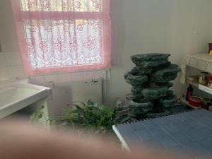 a bathroom with a window and a stone stove at Koskelo in Kiuruvesi