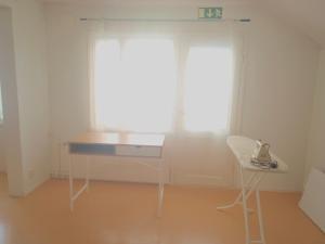 a desk and a chair in a room with a window at Koskelo in Kiuruvesi +6 photos