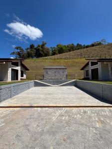 a large concrete parking lot with a building in the background at Chalé Estalagem Sítio Sossego in Domingos Martins