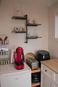 a kitchen with a red appliance on a counter at HavenRidge Alpaca Glamping Cabins in Kaiwaka