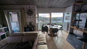 a living room with a couch and a table with chairs at Chez igor in Pétange