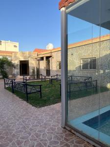 a view of a building through a glass door at شالهيات ريست 2 in Hail