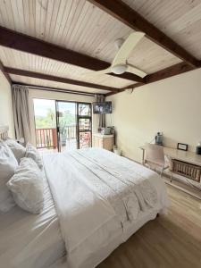 a bedroom with a large white bed and a window at The Hide on 37 Flamingo in East London