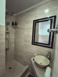 a bathroom with a sink and a shower with a mirror at ÁMBAR DEPARTAMENT boutique in Monte Grande +20 photos