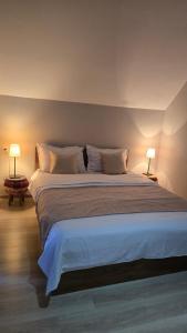 a bedroom with a large bed with two lamps at Chalet Weekend in Borjomi +95 photos