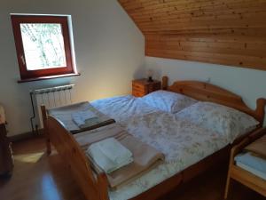 a bedroom with a bed in a room with a window at Apartment Zorc in Trenta