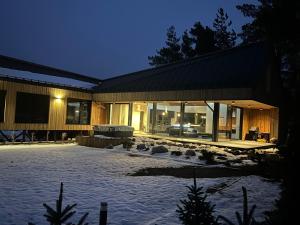 a house with a snow covered yard in front of it at Chalet Beyond in Veľká Lomnica +49 photos
