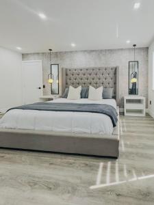 a bedroom with a large bed and two night stands at Casa Madrisqui Heated Pool Oasis 12 Guests Midway Keys & Miami in Homestead