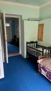a bedroom with two beds and a hallway with a mirror at Sheki Ev Guest House in Sheki +16 photos