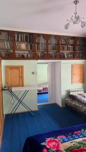 a room with a desk and shelves with books at Sheki Ev Guest House in Sheki