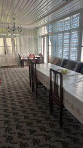 a dining room with a large table and chairs at Sheki Ev Guest House in Sheki