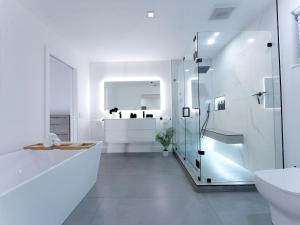 a white bathroom with a shower and a toilet at Casa Madrisqui Heated Pool Oasis 12 Guests Midway Keys & Miami in Homestead