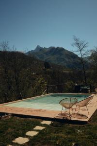 a table and chairs sitting on a wooden deck at Le Case di Rosie, Tuscan Mountain View apartment, Pool in Gragnola