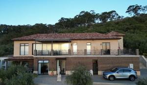 a house with a car parked in front of it at LIAPIS ESTATE Rostrevor Adelaide in Adelaide