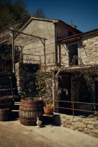 an old house with a large barrel and a building at Le Case di Rosie, Tuscan Mountain View apartment, Pool in Gragnola +28 photos