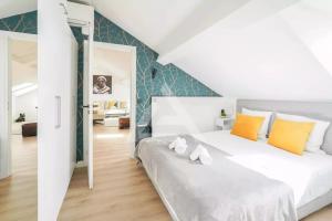 a bedroom with a large white bed with yellow pillows at Monte Carlo Monaco Border - luxury, modern, cozy with home feelings and See View in Beausoleil
