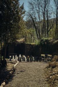 a garden with a group of white statues on the road at Le Case di Rosie, Tuscan Mountain View apartment, Pool in Gragnola