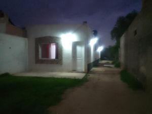 a house with lights on the side of it at night at Hospedaje Ayla in Tinogasta