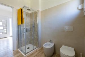 a bathroom with a shower and a toilet and a sink at Gradisca Go Home 2 in Gradisca dʼIsonzo +44 photos